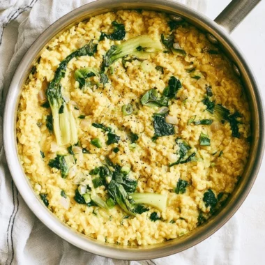 Bowl of creamy coconut rice garnished with herbs and spices for anti-inflammatory benefits.