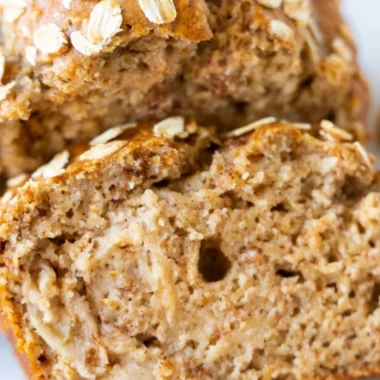 Loaf of homemade Banana Oatmeal Bread on a cutting board