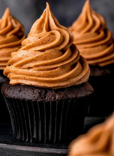 Cozy chocolate pumpkin cupcakes topped with creamy frosting and autumn spices.