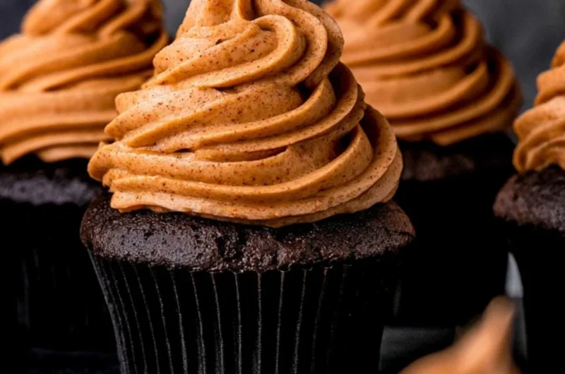 Cozy chocolate pumpkin cupcakes topped with creamy frosting and autumn spices.