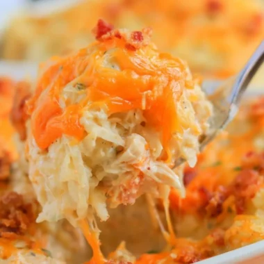 Deliciously baked Crack Chicken Casserole topped with cheese and herbs.