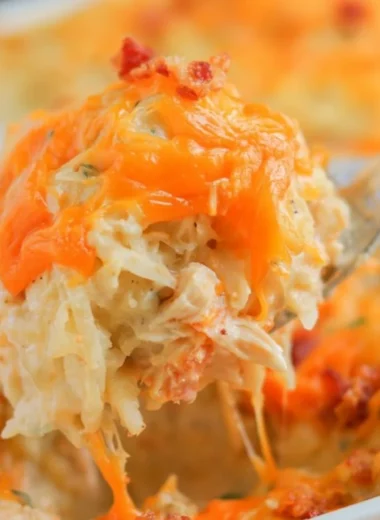 Deliciously baked Crack Chicken Casserole topped with cheese and herbs.