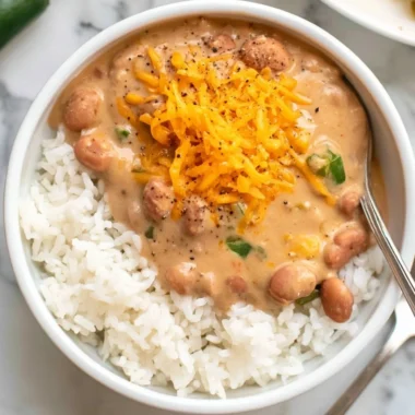 A bowl of cozy easy pinto beans garnished with herbs and spices