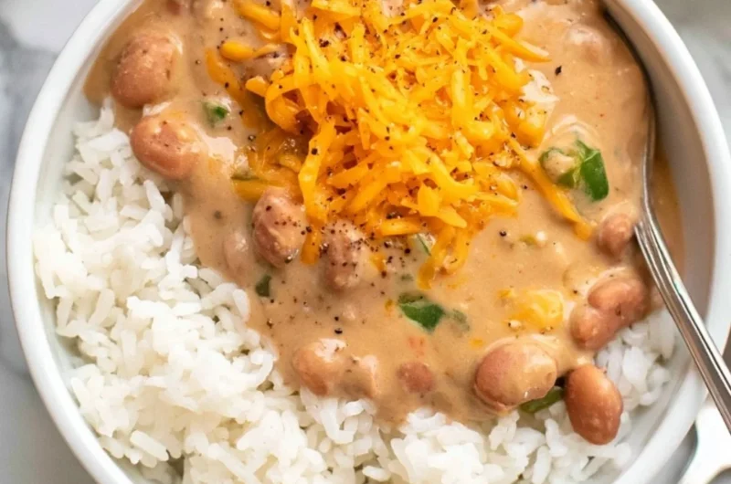 A bowl of cozy easy pinto beans garnished with herbs and spices