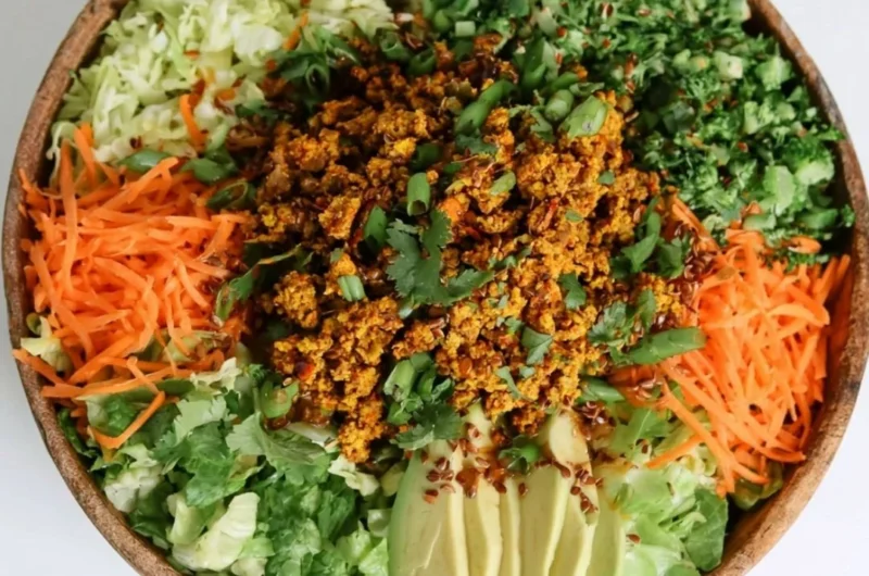 Cozy egg roll salad in a bowl with fresh ingredients and colorful toppings