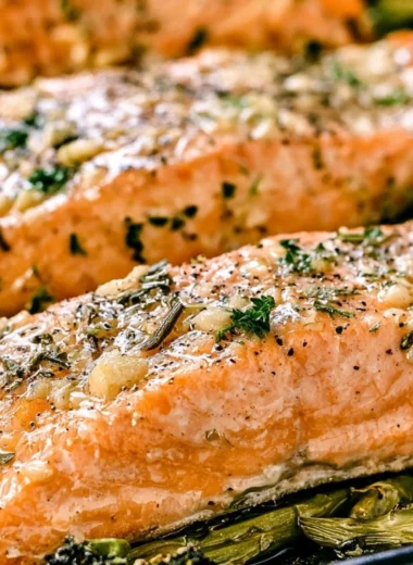 Cozy Garlic Butter Baked Salmon with herbs and lemon on a serving plate