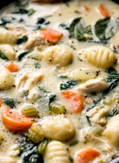Bowl of creamy Crockpot Chicken Gnocchi Soup with vegetables and herbs