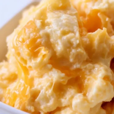 Easy Cheesy Potato Casserole served in a dish, topped with melted cheese.