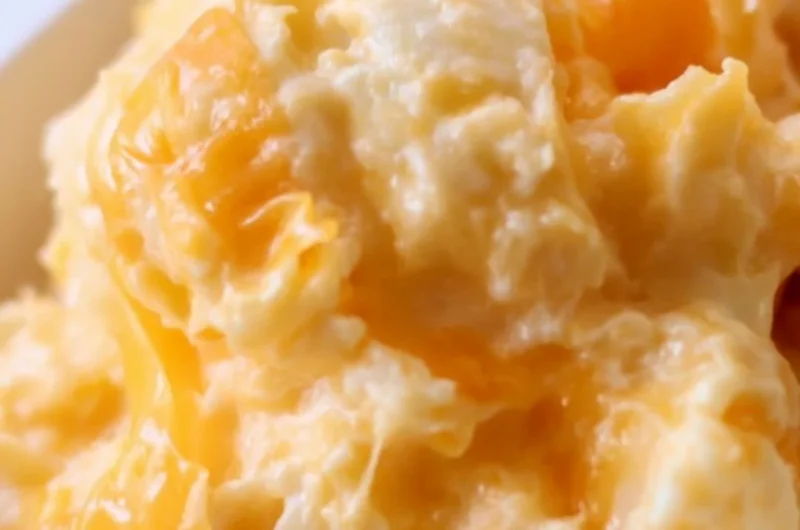 Easy Cheesy Potato Casserole served in a dish, topped with melted cheese.