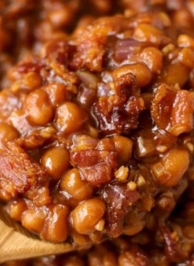 A delicious dish of easy ultimate baked beans garnished with herbs