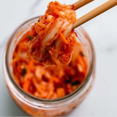 Bowl of homemade kimchi with vibrant vegetables and spices