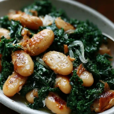 A serving of pan-fried beans with kale garnished with herbs
