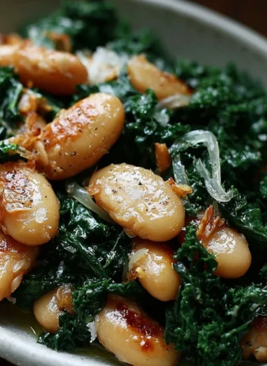 A serving of pan-fried beans with kale garnished with herbs