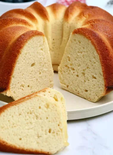 Delicious slice of Million Dollar Pound Cake on a white plate