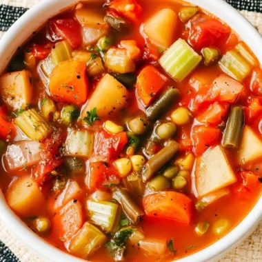 Hearty vegetable soup in a bowl with colorful vegetables