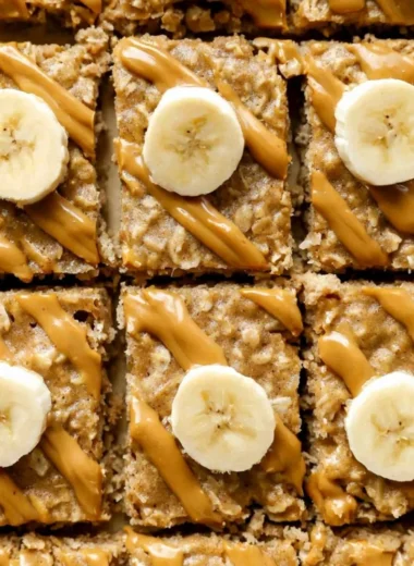 Delicious easy peanut butter baked oatmeal in a bowl, topped with banana slices.