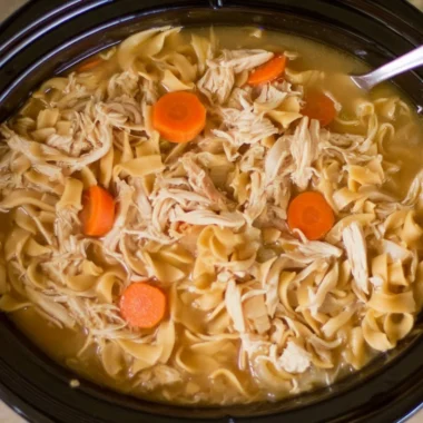 Bowl of high protein chicken noodle soup with vegetables and noodles