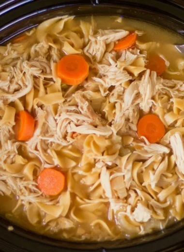 Bowl of high protein chicken noodle soup with vegetables and noodles
