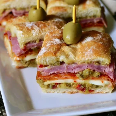New Orleans style muffaletta sandwich bites with olives and meats.