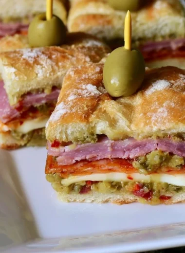 New Orleans style muffaletta sandwich bites with olives and meats.